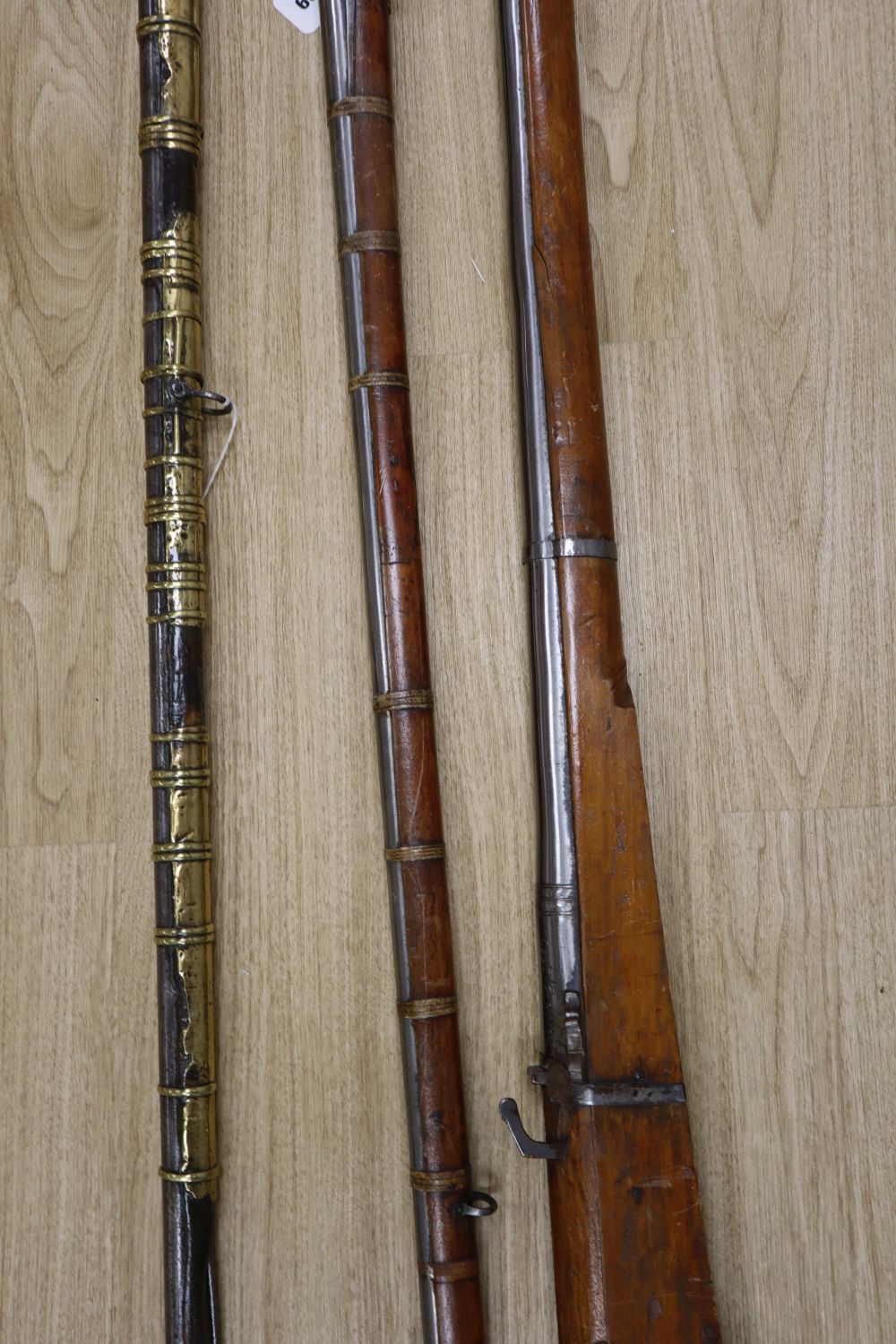 A long musket, overall 90 inches and two further longarms, all with ram-rods